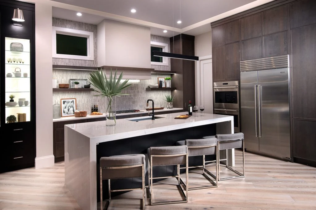Contemporary dark wood kitchen cabinetry and a sculptural pale island