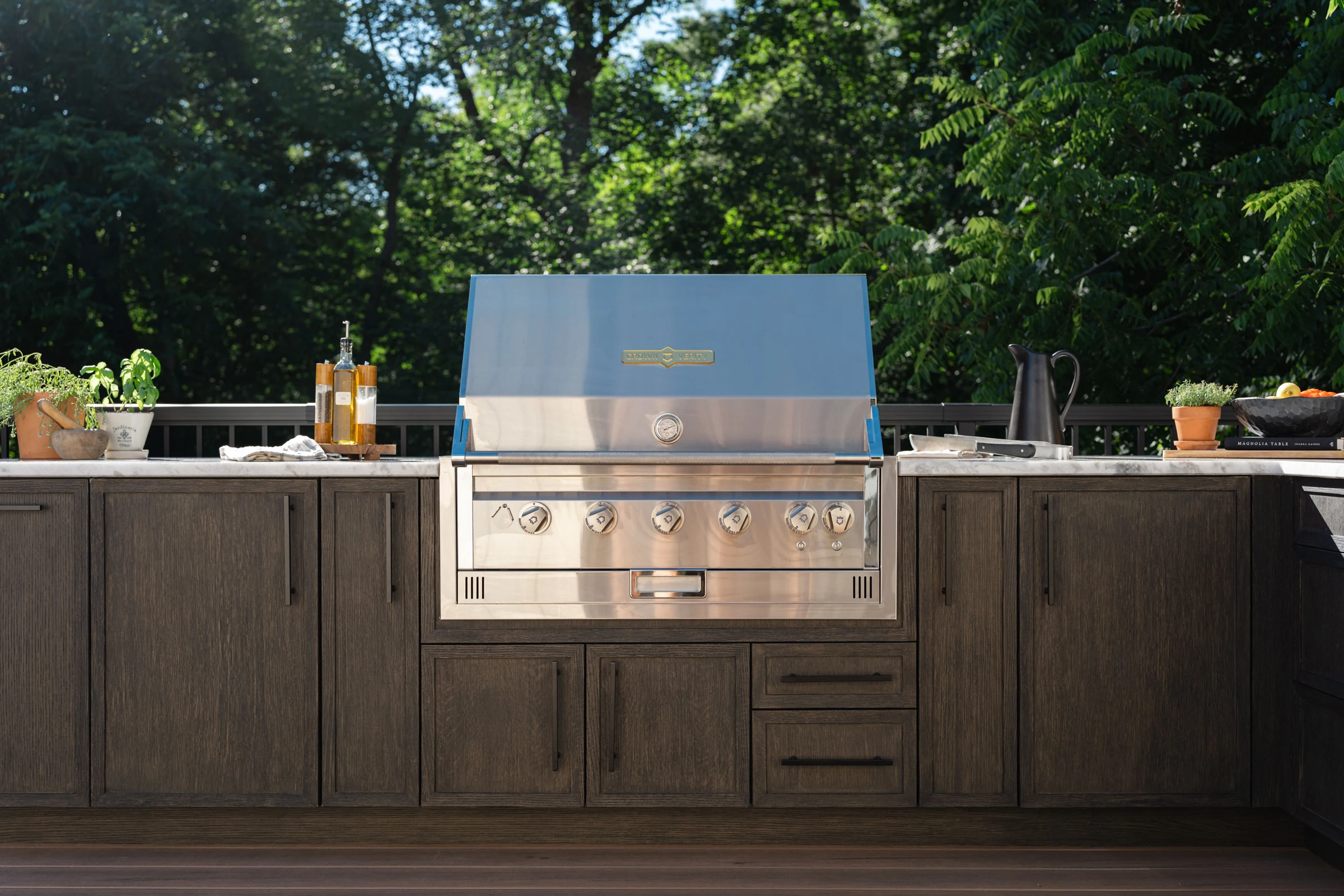 Brown slim shaker outdoor cabinetry around a stainless grill