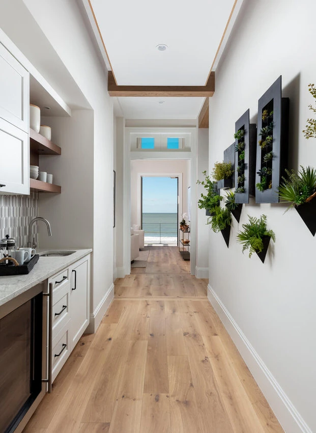 Long bright laundry room with fitted cabinetry and practical counter space