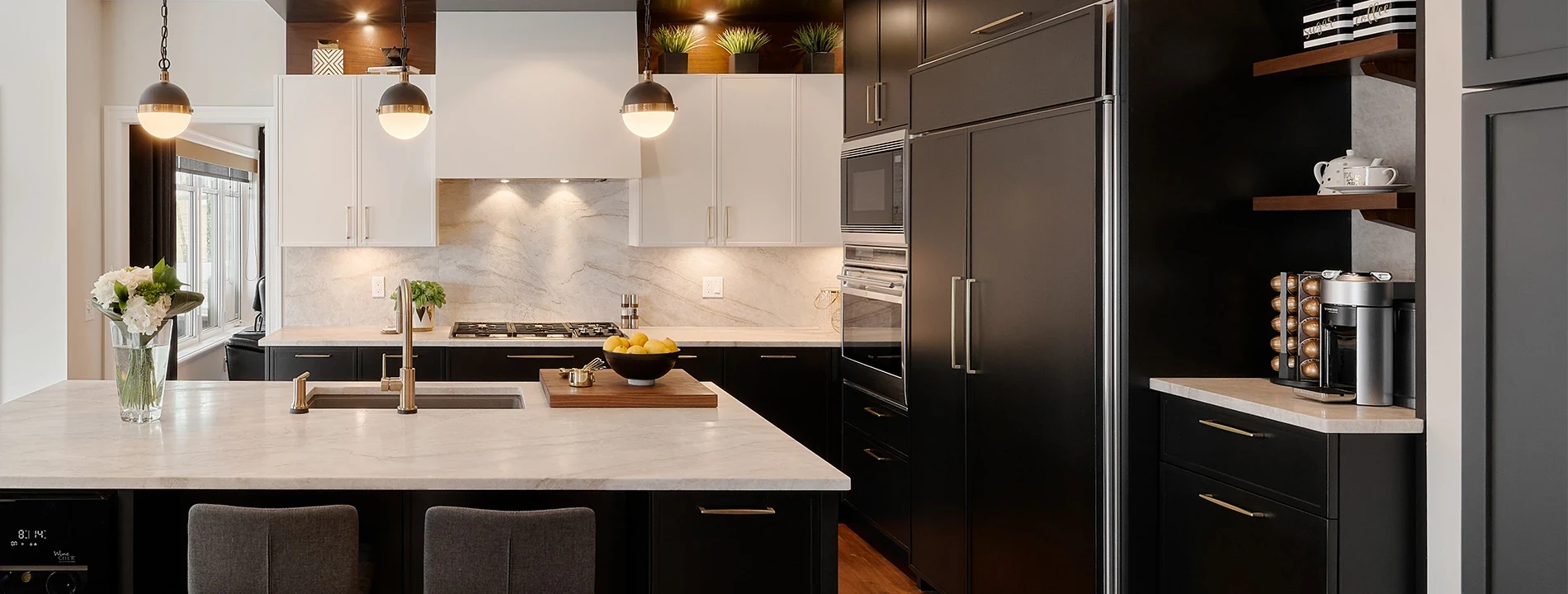 Elmwood kitchen with contrasting cabinetry, brass pulls, and integrated storage